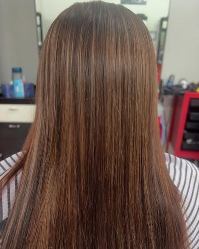 Caramel balayage with face-framing highlights on brunette hair